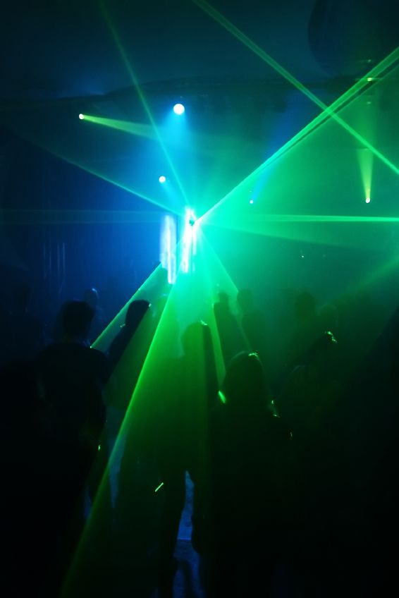 photo of people dancing in dark smokey club